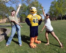 Two students flanking Solomon Seahawk mascot